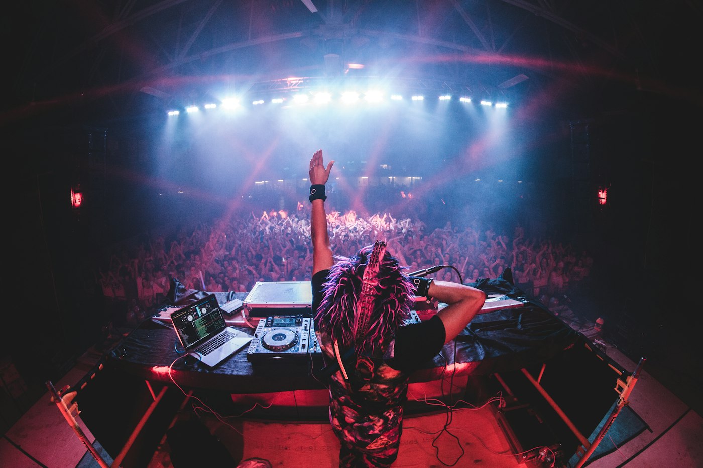 DJ performing under stage lighting